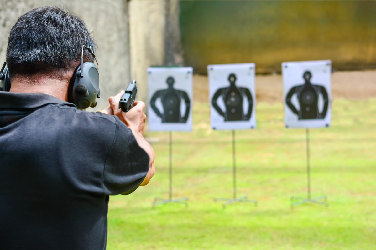 the man shooting with gun